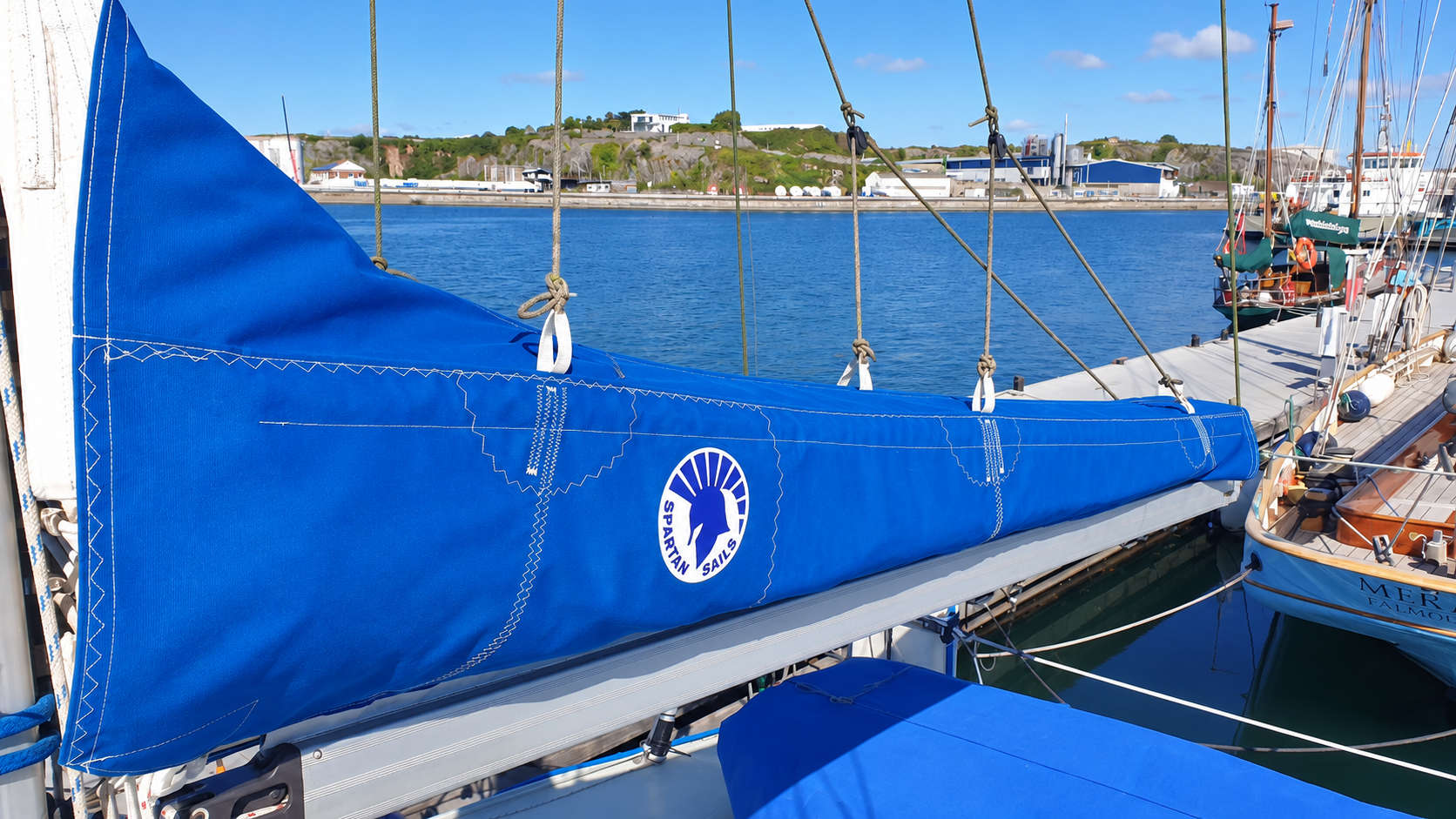 Spartan Hippeis blue integrated mainsail cover showing reinforced stitching and fittings